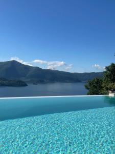 a swimming pool with a view of a lake at MIA ISOLA with lake view, garden and swimming pool in Parzanica