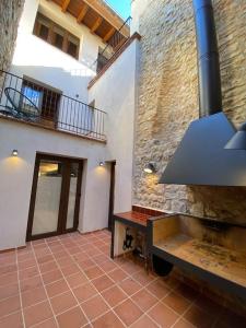 a room with a stone wall and a stove at Ca la tita Casa rural**** in Salsadella