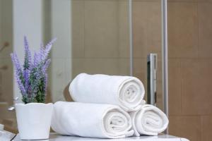 a stack of towels on a table in front of a mirror at MIA ISOLA with lake view, garden and swimming pool in Parzanica