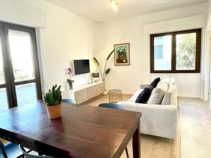 a living room with a couch and a table at Poetto Beach House - Molara1 in Cagliari