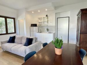 a living room with a table and a couch at Poetto Beach House - Molara1 in Cagliari