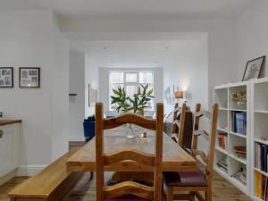 a dining room with a wooden table and chairs at Pass the Keys Large Family Home in Cheadle
