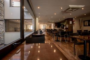 a dining room with tables and chairs in a restaurant at Ayres De Salta Hotel in Salta