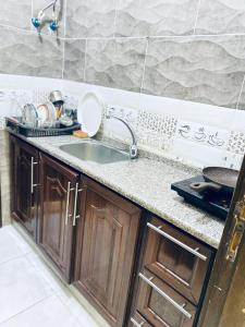 a kitchen with a sink and a counter top at Huwari Apartments in Aqaba