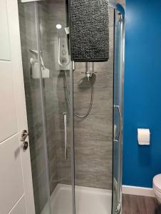a shower with a glass door in a bathroom at Smart modern studio flat in central Bournemouth in Bournemouth
