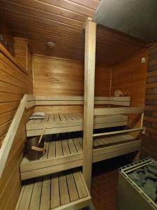 a wooden sauna with two beds and a bucket at Wera in Porvoo