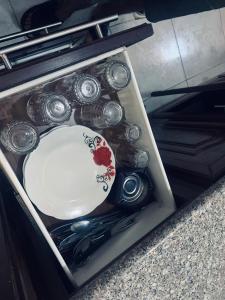 a drawer filled with a plate and some dishes at Huwari Apartments in Aqaba