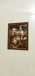 a framed picture of dogs on a wall at Hornbill inn in Cochin