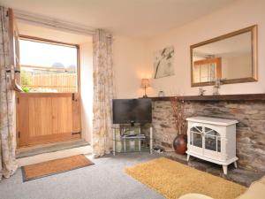 a living room with a television and a fireplace at 1 Bed in Bude 43697 in Morwenstow