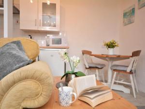 a living room with a couch and a table with books at 1 Bed in Bude 43697 in Morwenstow