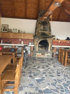 a living room with a stone fireplace with a bike at Ubytování Pohoda in Šumperk