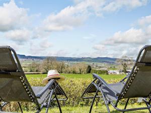 two chairs with a hat sitting on them in a field at 2 Bed in Axminster 45099 in Axminster