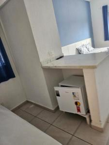 una cucina con tavolo e piccolo frigorifero di Hotel e Marina nova pier 22 a Caraguatatuba