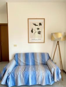 a bed in a room with a picture on the wall at Residenza Camilla in Vicenza