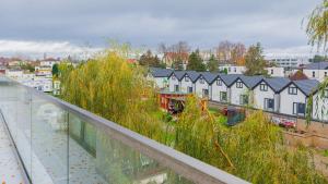 a view of a city with houses and grass at VacationClub - Siedem Wysp Apartament 31 in Sianozety