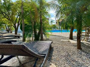 a resort with a bench and trees and a swimming pool at Villa Saraceno in Lipari