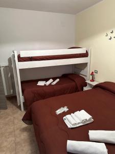 two beds in a room with two bunk beds at Claudia B&B in Pescasseroli