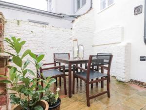 a table and chairs with candles on a patio at Kestrel Cottage in Middlesbrough