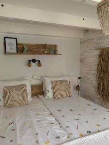 a bedroom with a large bed with two pillows at Appartement 't Souterrain in Zandvoort