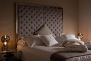 a bedroom with a white bed with a large headboard at Luxury Villa Claretta near Porec for 8 people with sea view & pet friendly in Vabriga