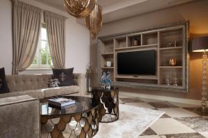 a living room with a couch and a television at Luxury Villa Constanza near Poreč for 8 people only 2 km from the sea in Vabriga