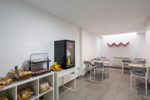 a dining room with chairs and a counter with food at Alda Soria Rooms in Soria