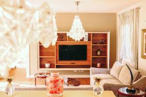 a living room with a couch and a television at Luxury Villa Fiordaliso near Poreč for 6 people with private pool & sea view in Vabriga