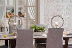 a dining room with a table and chairs at Luxury Villa Fiordaliso near Poreč for 6 people with private pool & sea view in Vabriga +19 photos