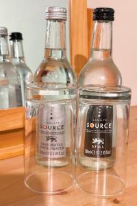 three bottles of vinegar and a glass jar on a table at Penybont Restaurant + Inn in Carmarthen