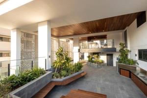 a lobby of a building with plants at Riverview Haven Prime Spot for NY Fireworks in Brisbane