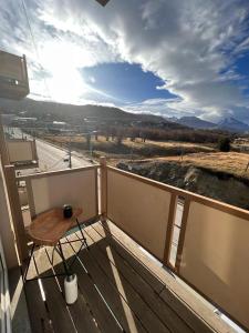 a balcony with a wooden table and a view at Potken - Depto vistas increíbles, cálido y acogedor in Ushuaia
