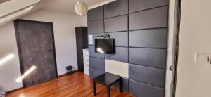 a room with a wall with a tv on it at M Hostel in Gliwice