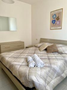a bedroom with a bed with two towels on it at Residenza Camilla in Vicenza