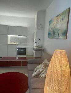 a living room with a couch and a kitchen at Civico 45 in Ancona