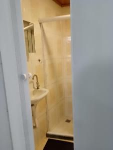 a bathroom with a shower and a sink at Flats do Cordeiro in Cabo Frio