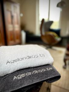 a white towel with the words associatedomnia sitting on a table at L'atique by Agelandkaai be with Free Parking in Ghent