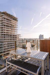 a table on a balcony with a building at Huswell - Brand new apartment with terrace - pets welcome! in Ostend