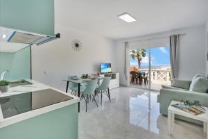 a kitchen and living room with a view of the ocean at Luxury Romantic Ocean View in Adeje