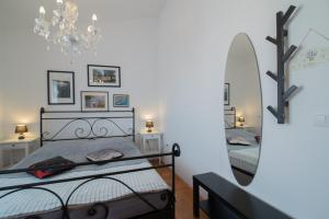 a bedroom with two beds and a mirror at Hotel Villa Vera 2 in Fažana