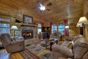 a living room with couches and a fireplace at Papa Bear's Den in Cherry Log