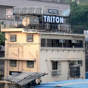 a building with a train on top of it at Hotel Sion TriTon - Sion Mumbai Hotels in Mumbai