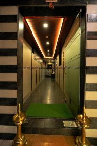 a hallway with a green floor in a building at Hotel Sion TriTon - Sion Mumbai Hotels in Mumbai
