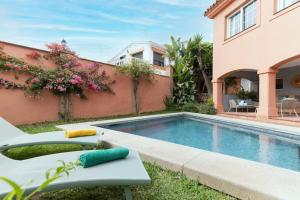 a swimming pool in front of a house at Traditional Spanish villa near Puerto Banus in Marbella