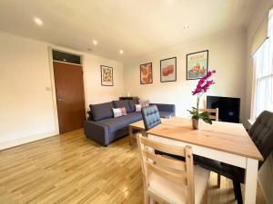 a living room with a couch and a table at Crouch End- 1 Bed Apartment in London