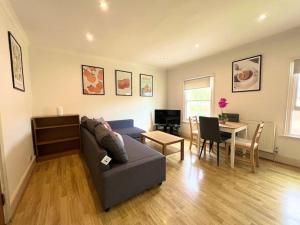 a living room with a couch and a table at Crouch End- 1 Bed Apartment in London