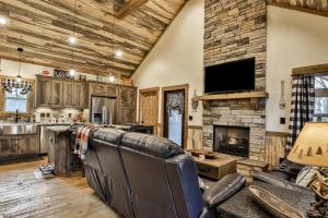a living room with leather furniture and a fireplace at French Kisses in Ellijay +22 photos