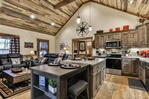 a kitchen with wooden cabinets and an island in a room at French Kisses in Ellijay