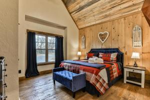 a bedroom with a bed with a wooden wall at French Kisses in Ellijay