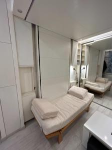 Cette chambre comprend un lit et un miroir. dans l'établissement Bright apartment in the heart of Paris, à Paris