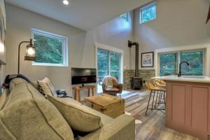 a living room with a couch and a kitchen at Creeksong in Ellijay